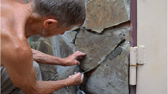 Facing the foundation of the house tiles sandstone.